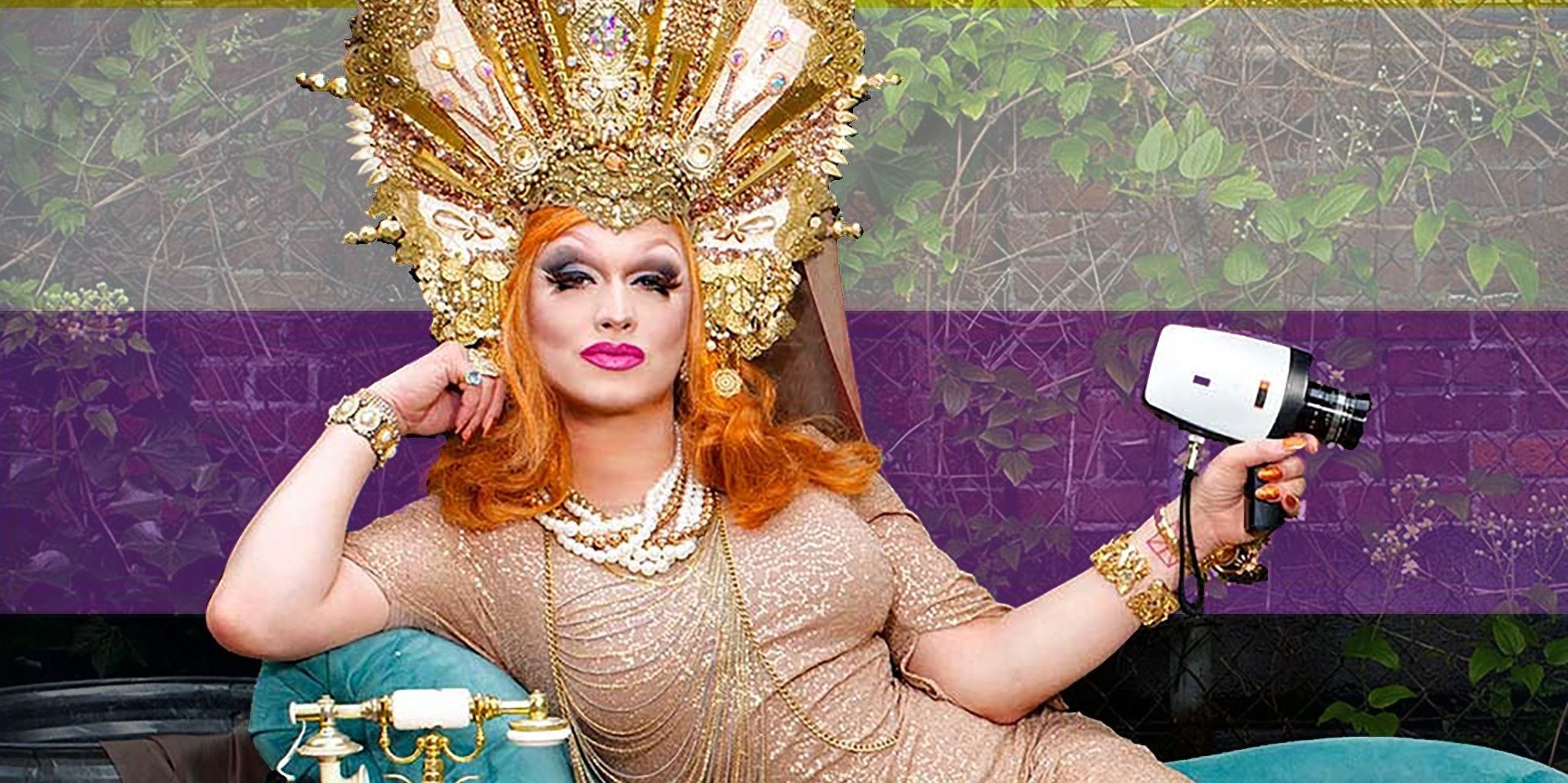 Jinkx holding a camera and wearing an elaborate headpiece. 