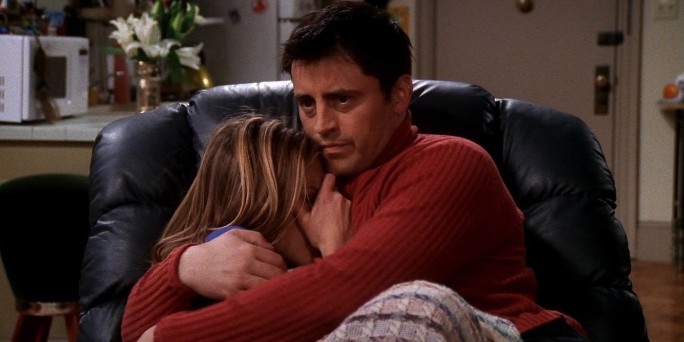 Joey comforts Rachel during a scary movie in Friends.