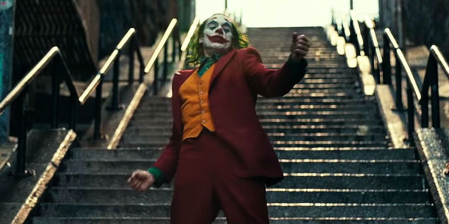 Joaquin Phoenix as Arthur Fleck dancing down stairs in Joker