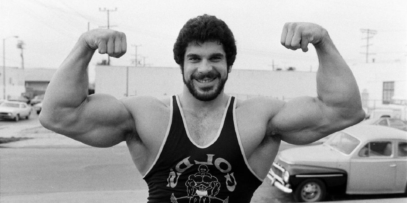 A black and white image of Lou Ferrigno flexing his muscles.