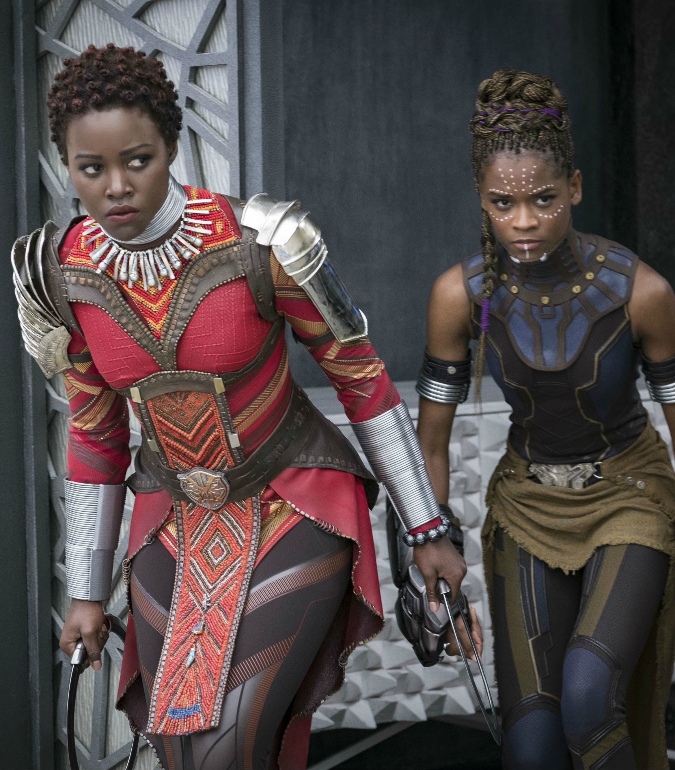 Lupita Nyong'o and Letitia Wright as Nakia and Shuri in Black Panther Veritcal