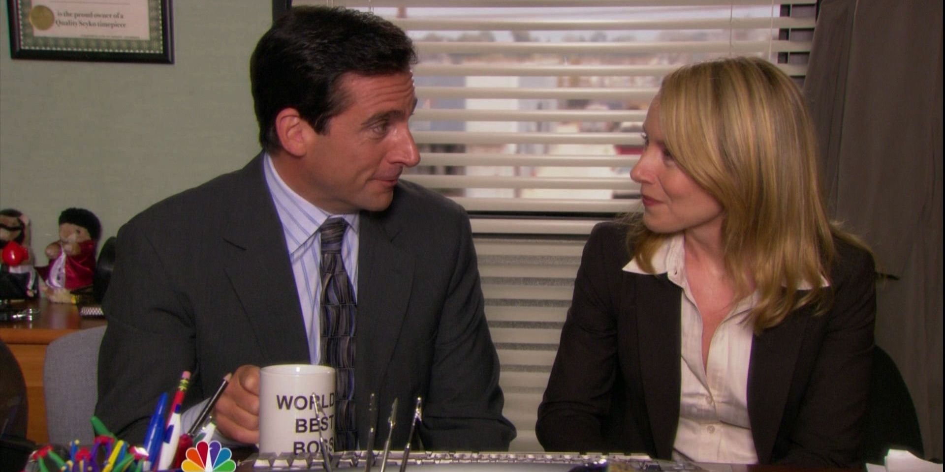 Michael and Holly from The Office sitting at a desk.