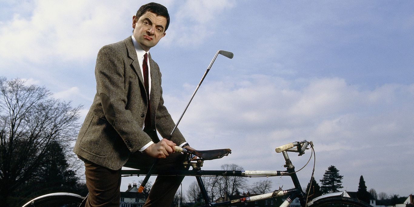 Mr Bean on a bike with a golf club 