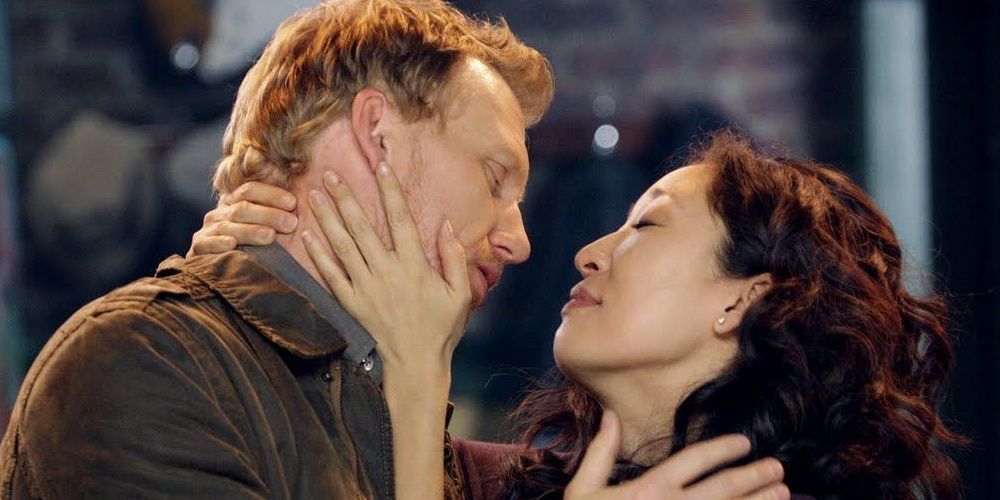 Owen and Cristina smile while embracing in Grey's Anatomy