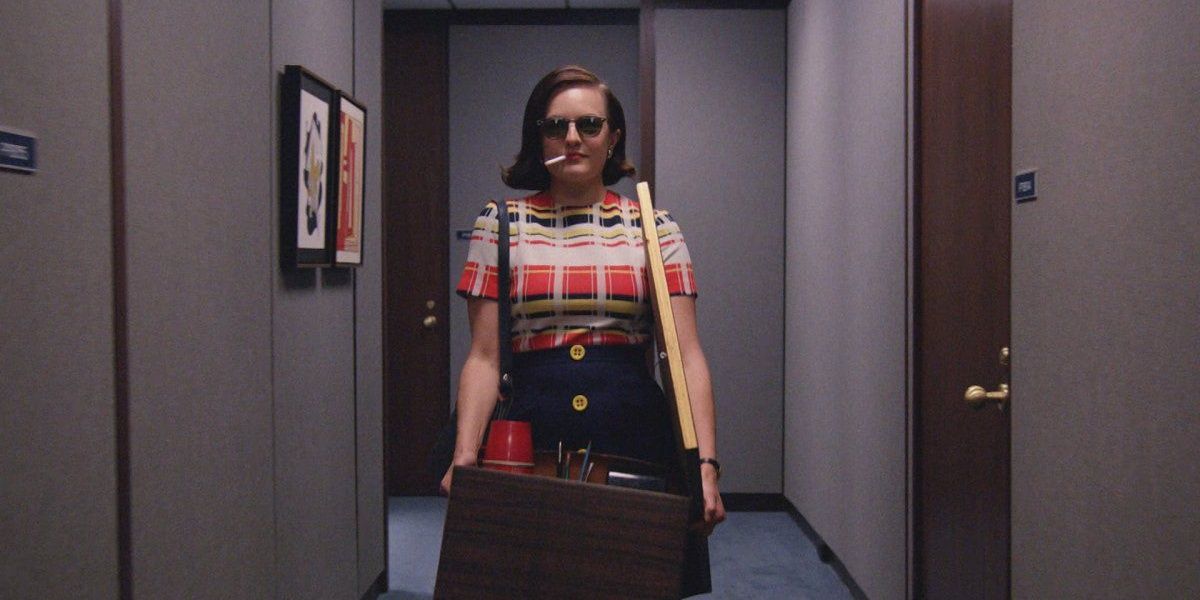 Peggy Olson carrying her box while smoking in Mad Men