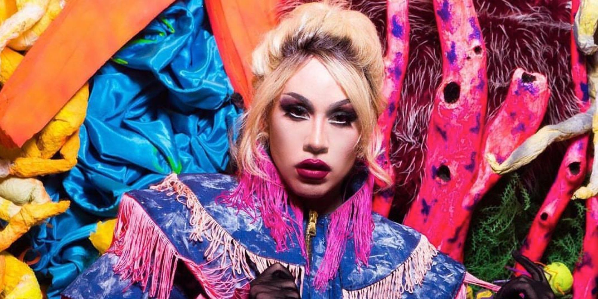 Phi Phi O'Hara in a colorful fringe jacket on RuPaul's Drag Race