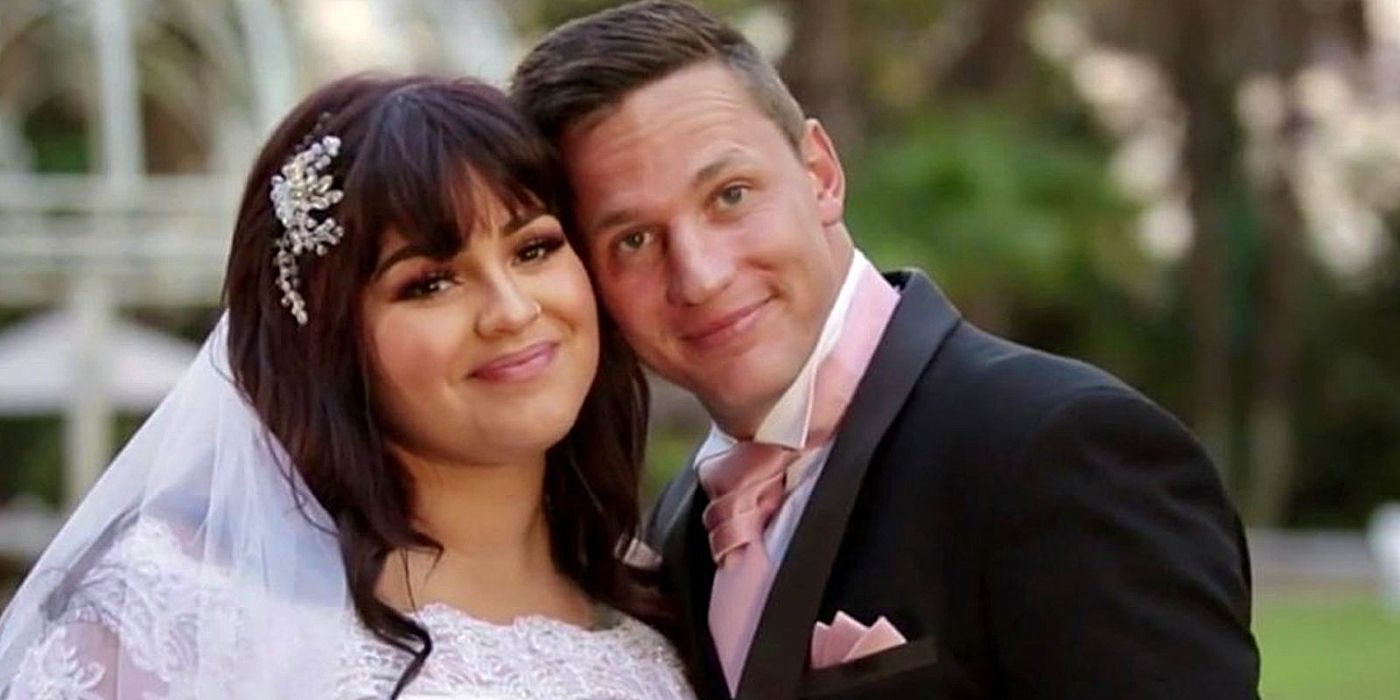 Ronald Smith and Tiffany Franco from 90 Day Fiancé: The Other Way on their wedding day, Ronald leaning on Tiffany. He wears a black suit and Tiffany is in a lacy white dress