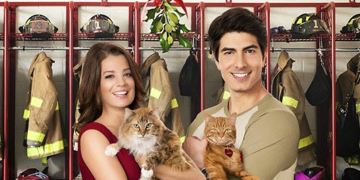 Merliee and Zack stand with their cats in front of the fire house lockers and under a mistletoe in The Nine Lives of Christmas