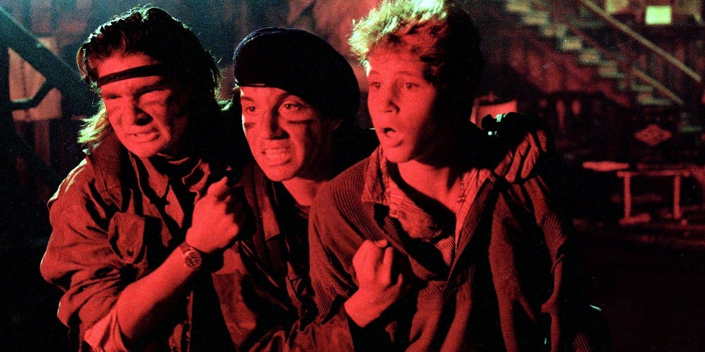 The Frog Brothers (Jamison Newlander and Corey Feldman) and Sam (Corey Haim) holding each other as they fight off vampires in The Lost Boys.