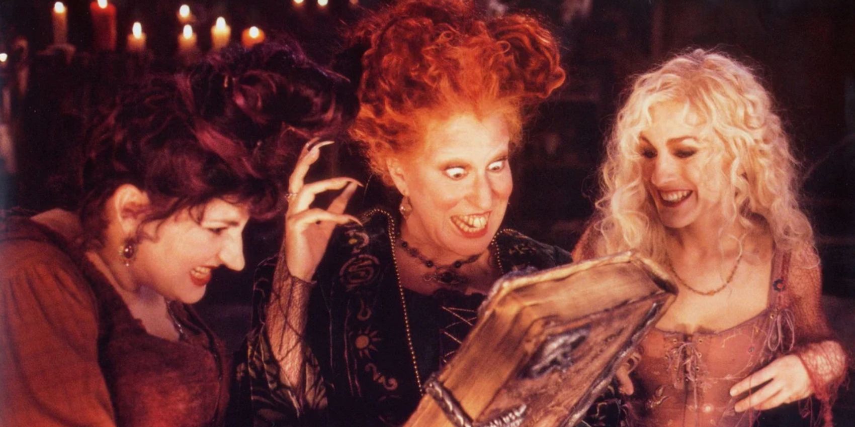 The Sanderson Sisters with the spellbook in Hocus Pocus
