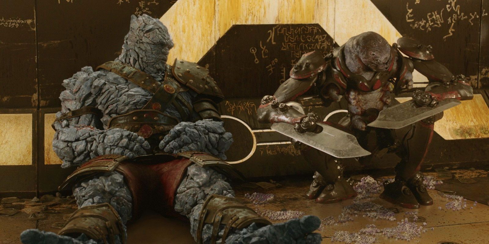 Korg and Miek sitting against wall in Thor Ragnarok