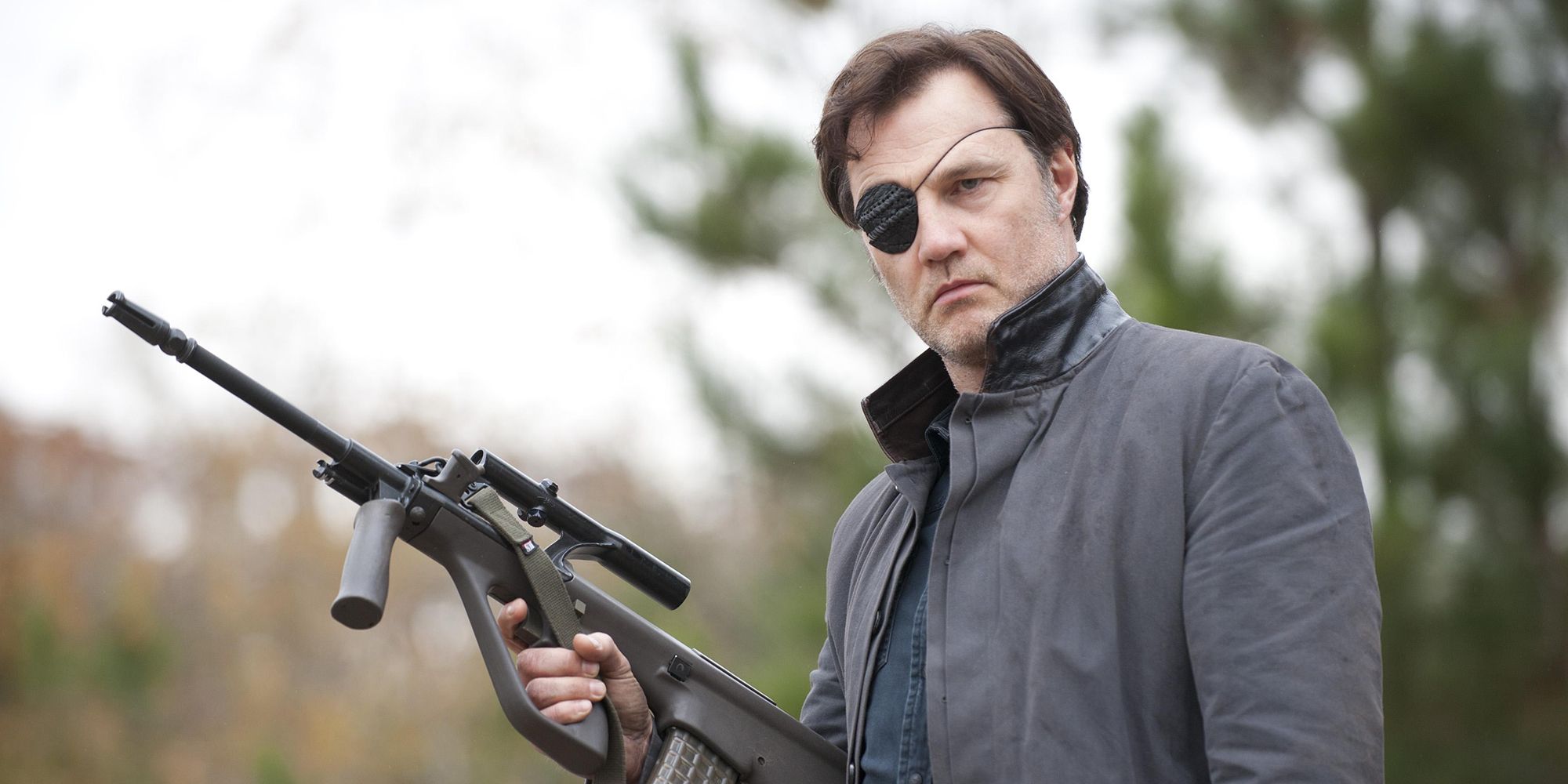 The Governor from The Walking Dead holding a rifle and wearing an eyepatch.