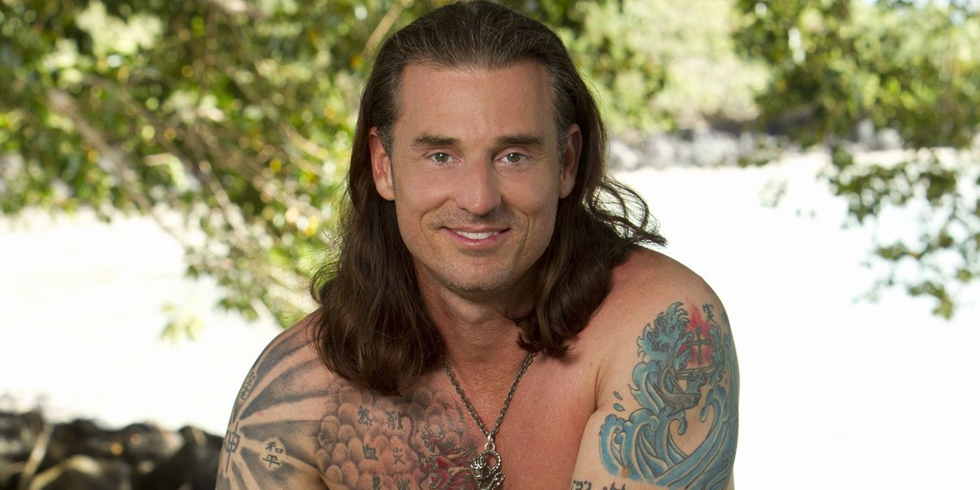 A headshot of Coach from Survivor, smiling.