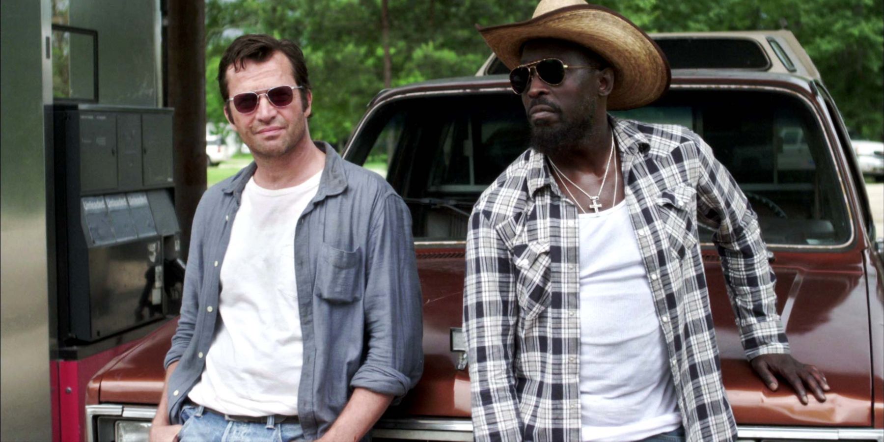 Hap and Leonard relax on the hood of a car in Hap & Leonard.