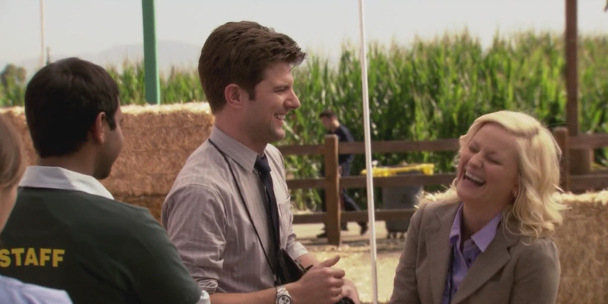 Leslie and Ben laugh together at the Harvest Festival in Parks and Recreation