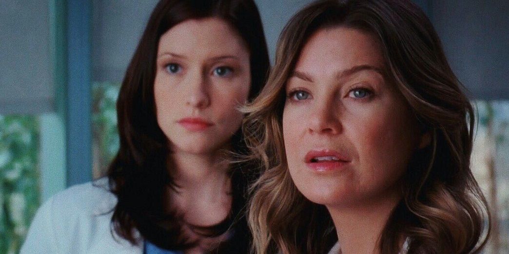 Lexie and Meredith standing together in the hospital on Grey's Anatomy