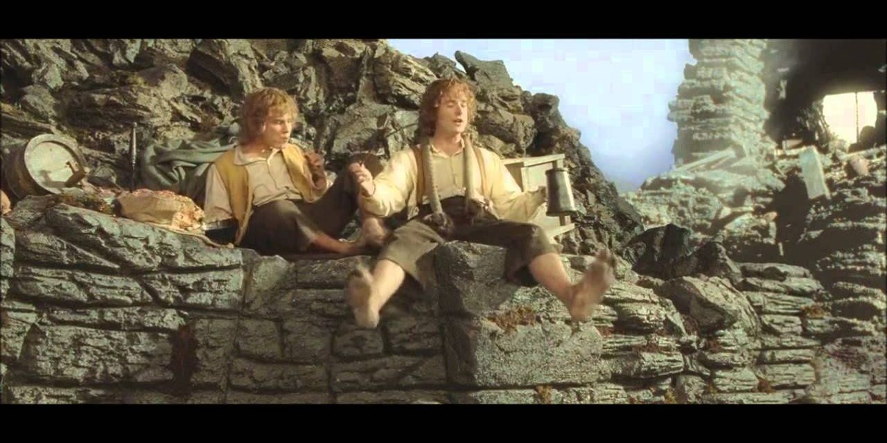 Merry and Pippin sitting on a rock drinking and smoking in The Lord of the Rings. 