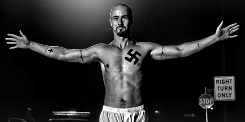 Edward Norton walking with arms raised in triumph and surrender in American History X