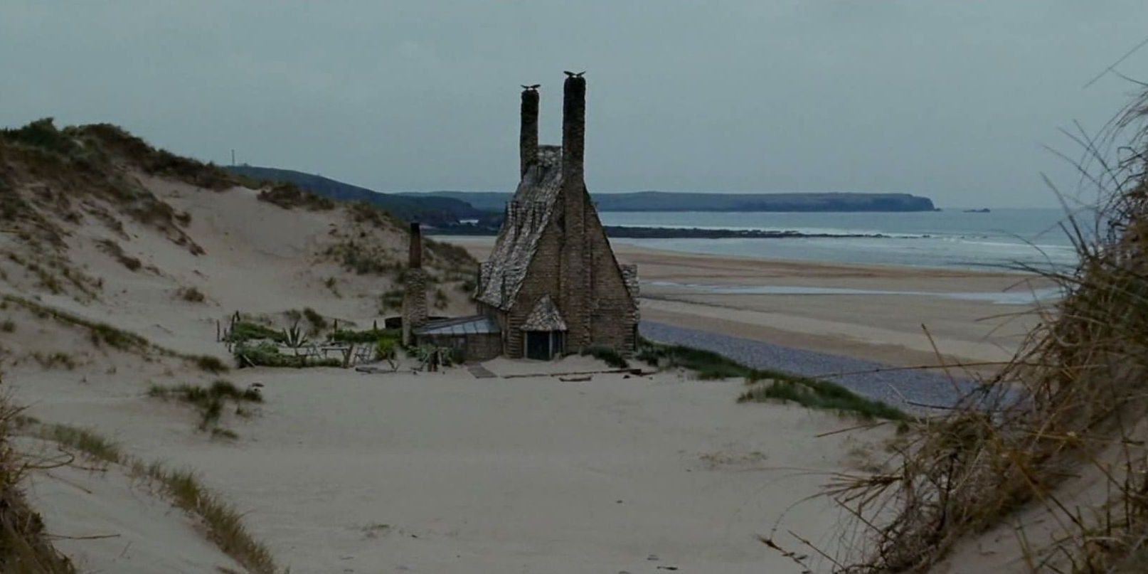 shell cottage from harry potter. Based near the sea, it's a building with two tall towers.