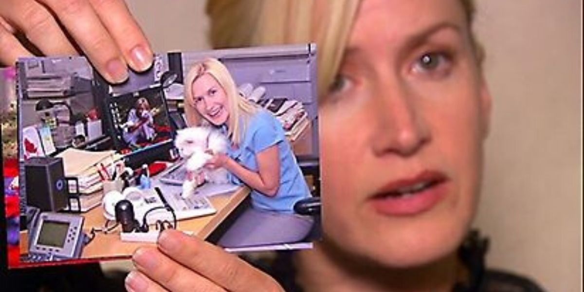 Angela from The Office holds up a photo of Sprinkles the cat.