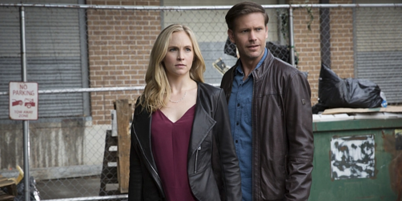 Alaric and Caroline stand next to each other in The Vampire Diaries.