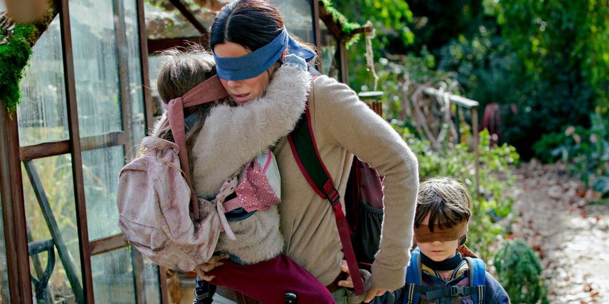 Sandra Bullock leading the kids with blindfolds on in Bird Box