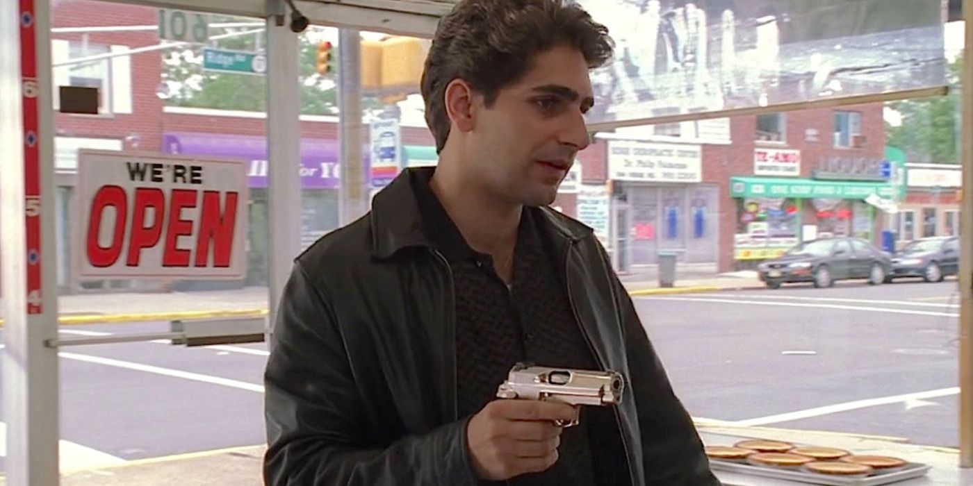 Christopher Moltisanti holds up a bakery store