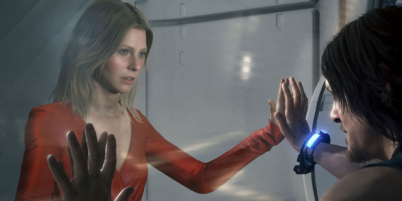 A photo of Amelie and Sam with their hands pressing against glass in the game Death Stranding.