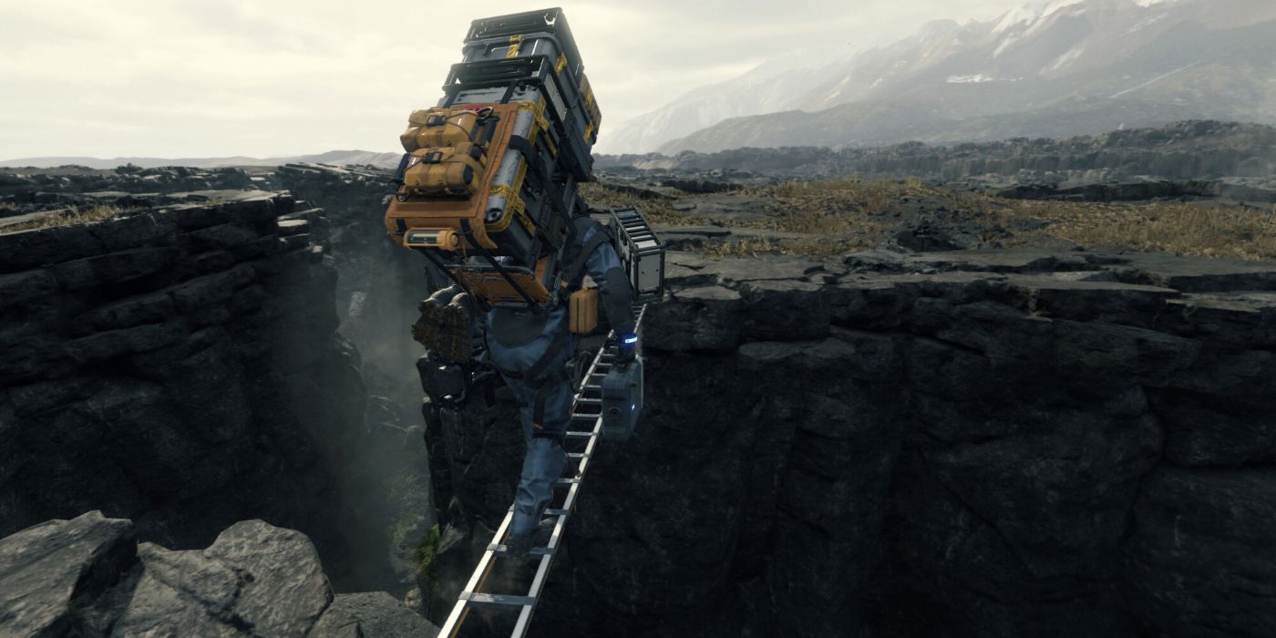 Death Stranding protagonist Sam Bridges crosses between two cliffs balancing loads of items and traversing an unsettlingly narrow ladder