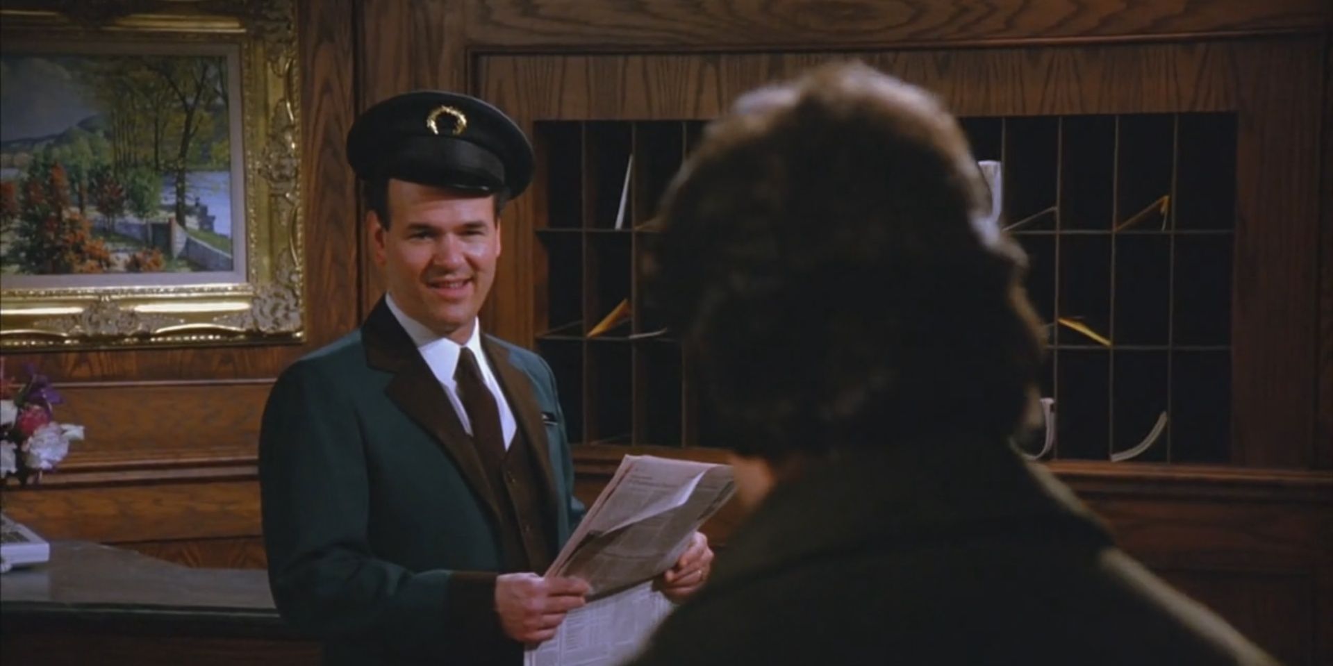The doorman smiling in Seinfeld
