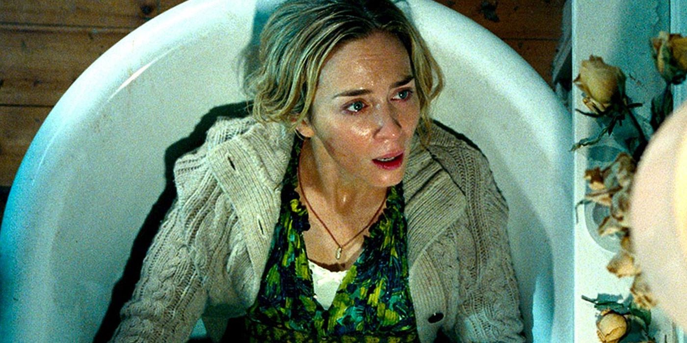 Evelyn hides from alien creatures in a bathtub in A Quiet Place