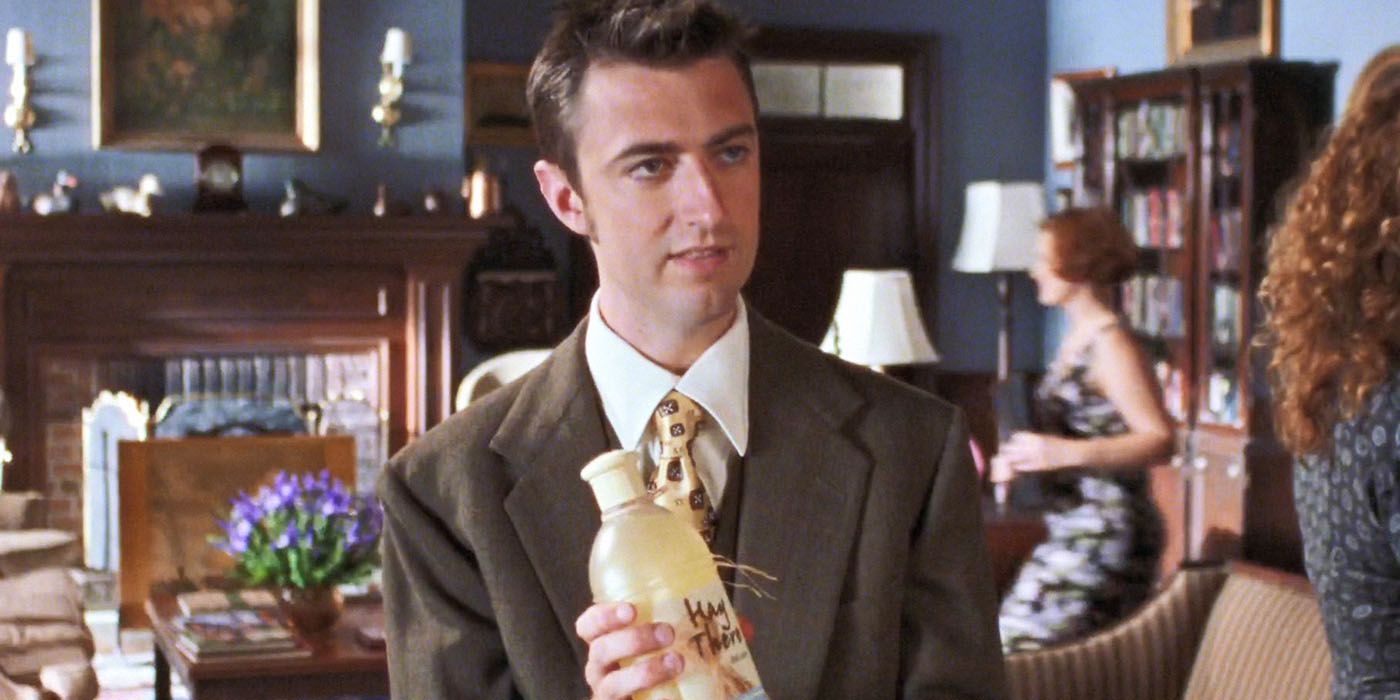 Kirk holding up a bottle of his product called Hay There on Gilmore Girls