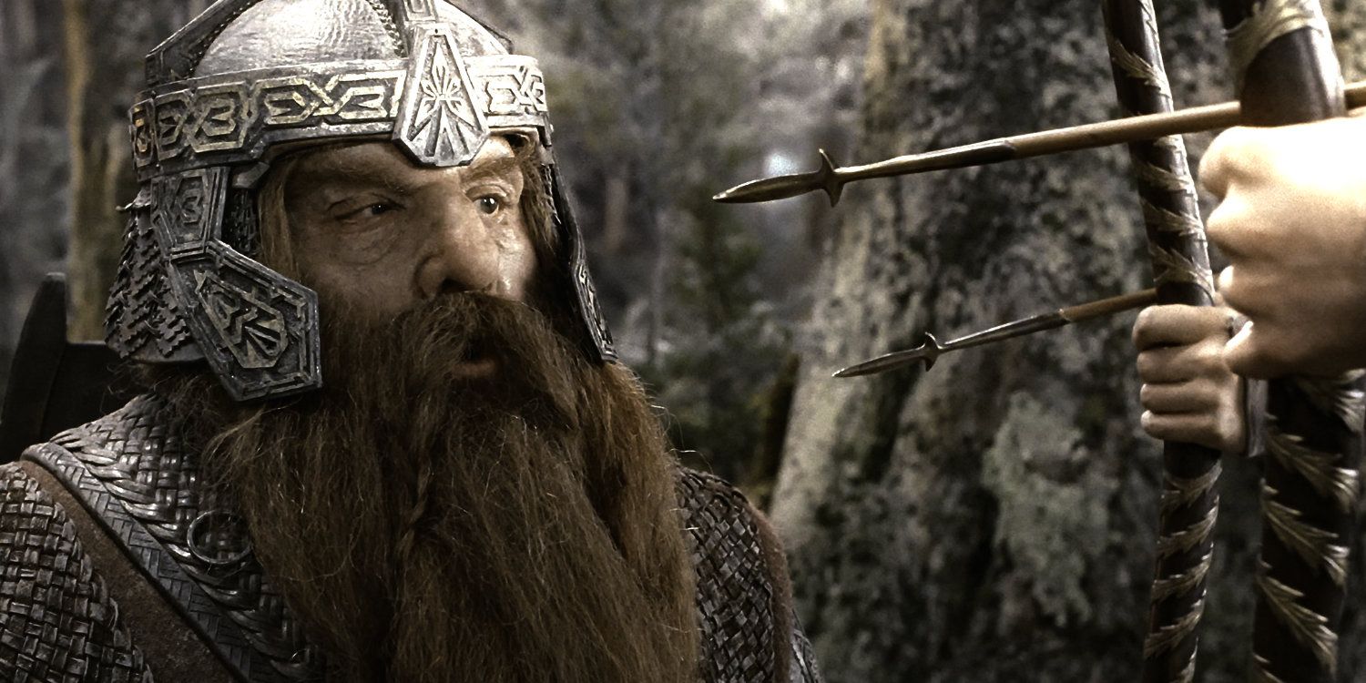 Gimli looking at a bow and arrow in The Fellowship of the Ring