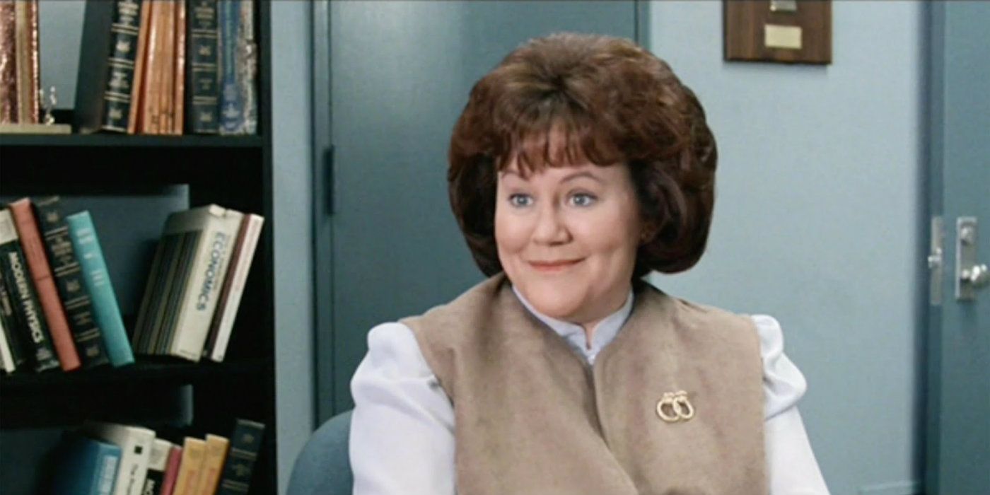 Grace the Secretary smiling at the viewer in Ferris Bueller's Day Off
