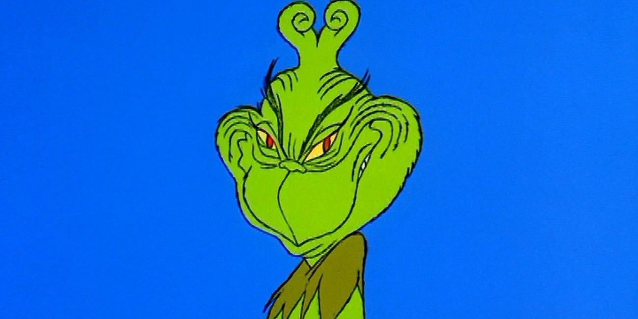 The Grinch grinning against a blue background in How the Grinch Stole Christmas.