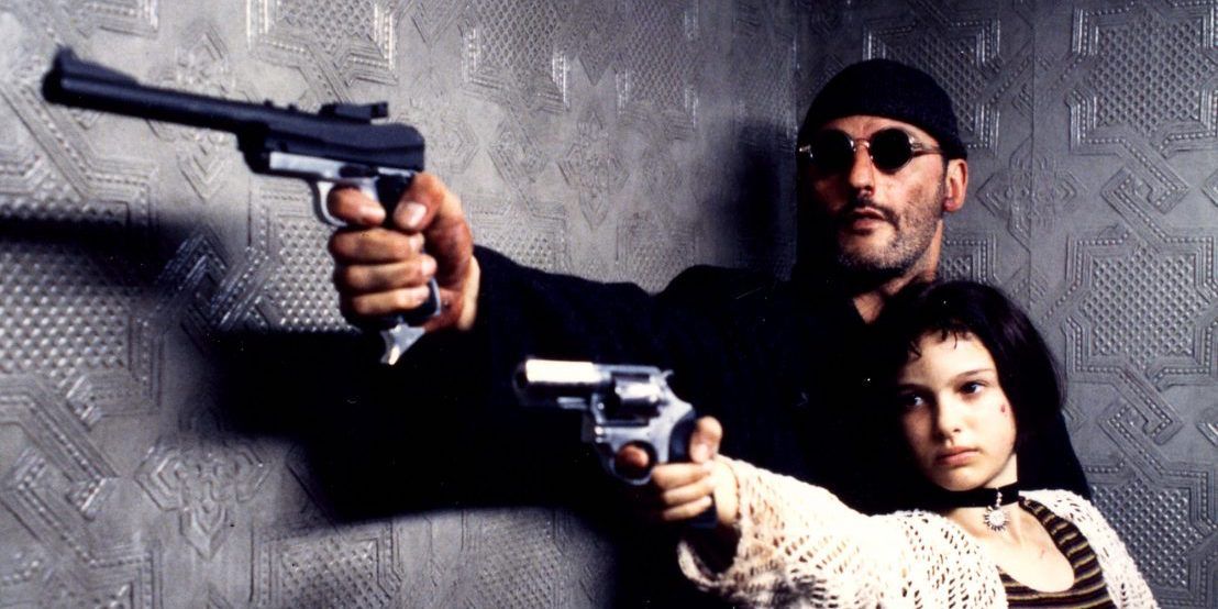 Jean Reno and Natalie Portman pointing guns in the same direction in Leon The Professional