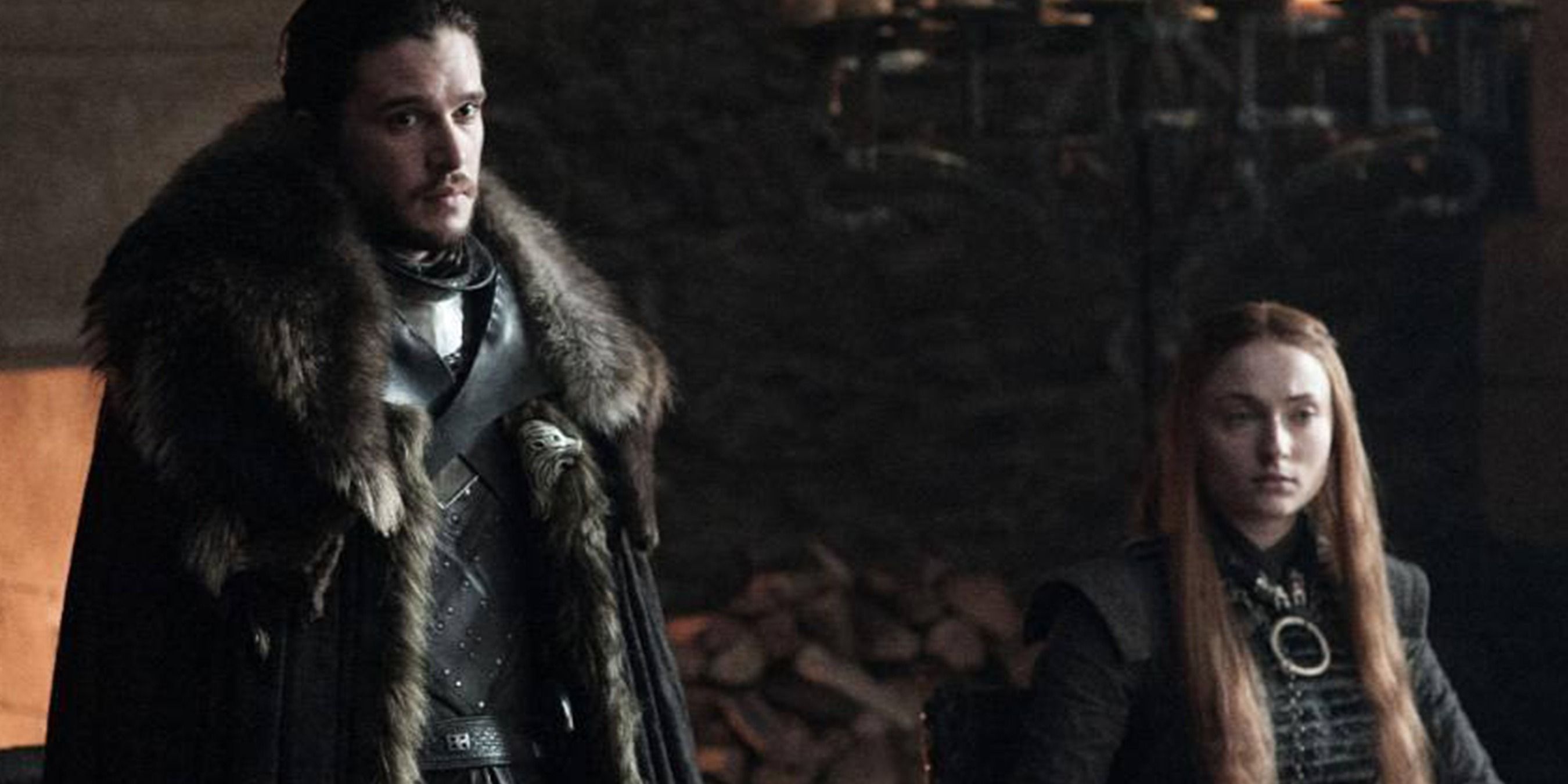 Jon Snow stands and Sansa Stark sits in Winterfell