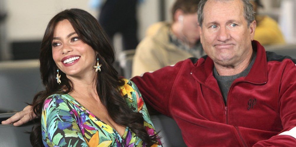 Jay and Gloria sitting in airport in Modern Family