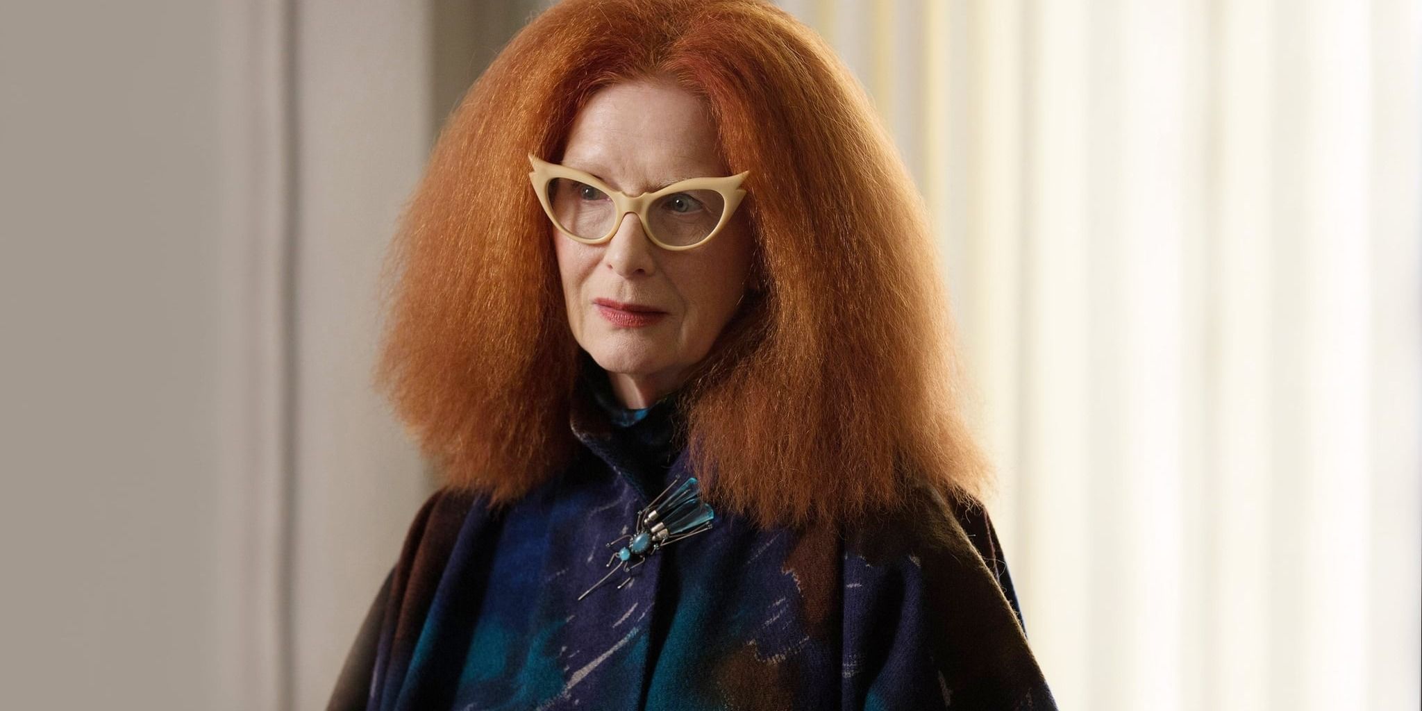 Myrtle Snow standing and looking at someone in American Horror Story: Coven