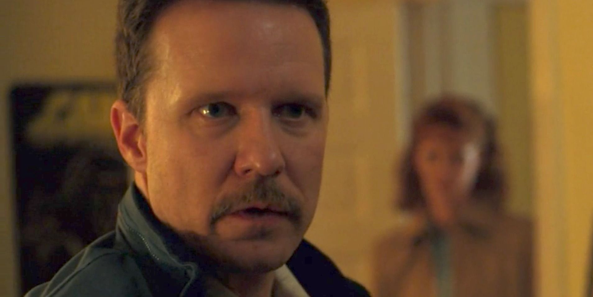 Neil Hargrove looks on with a threatening expression in Stranger Things.