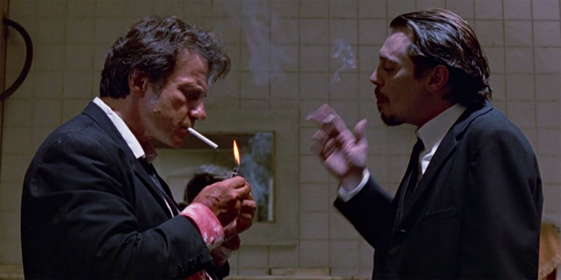 Mr White and Mr Pink smoke a cigarette in the warehouse in Reservoir Dogs