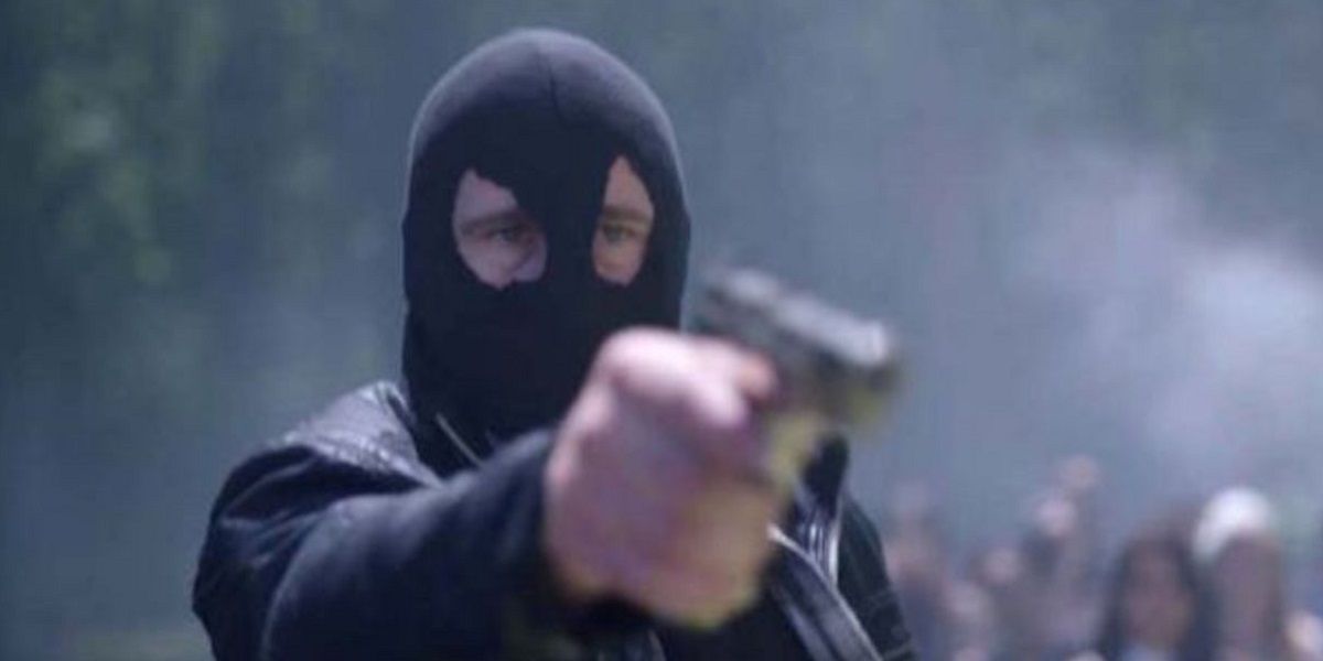 The black hood points a gun in a mask in Riverdale.