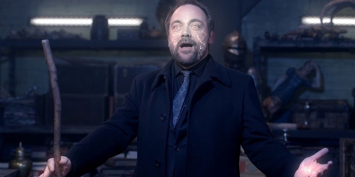 Crowley holds out his hands while showing off power in Supernatural