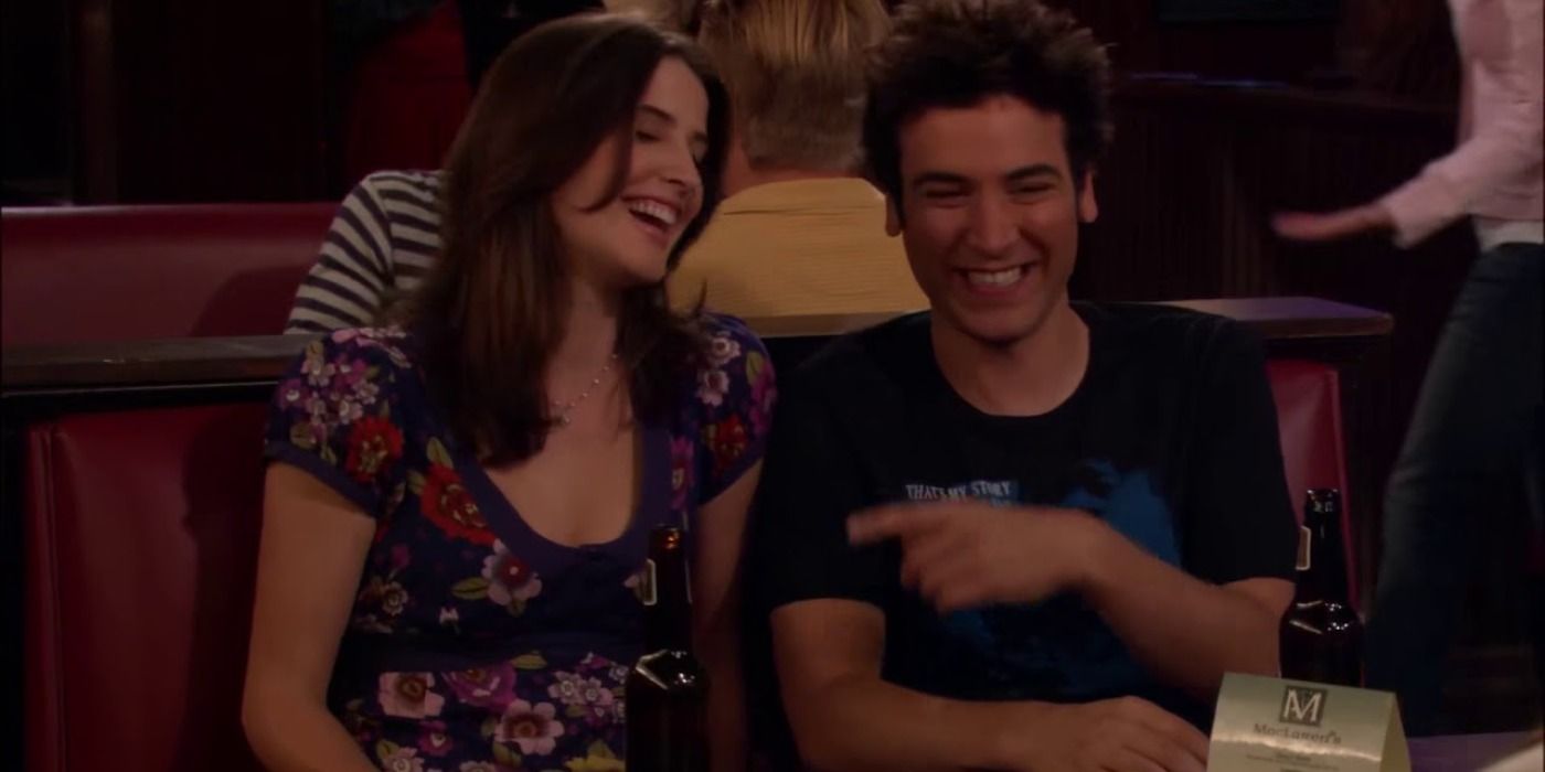 Ted and Robin laugh together after annoying the gang with their inside jokes in How I Met Your Mother