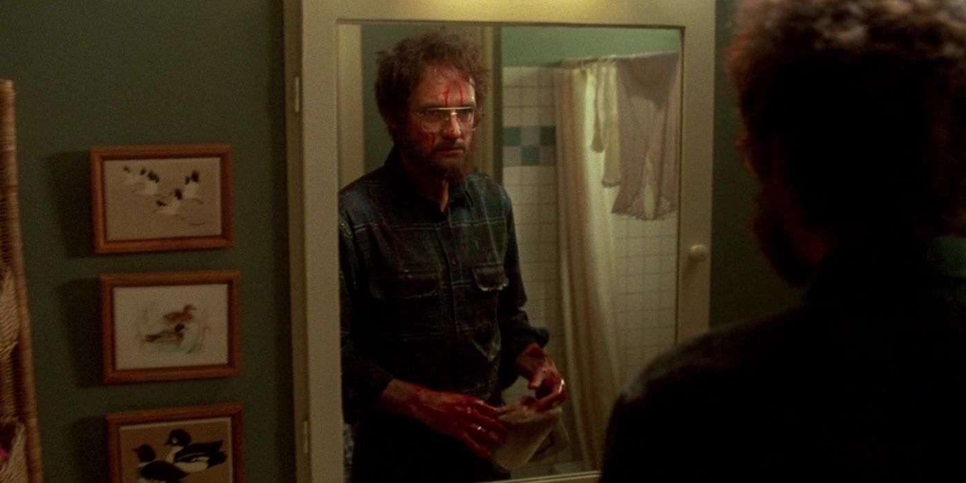 Terry O'Quinn looks at himself in the mirror from The Stepfather 