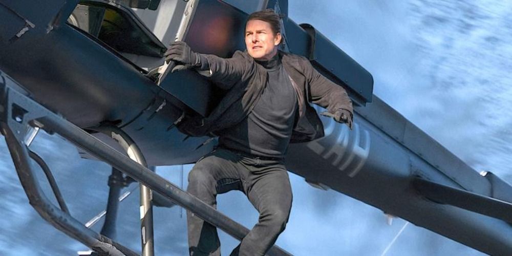 Ethan Hunt hanging onto the outside of a flying helicopter in Mission Impossible Fallout