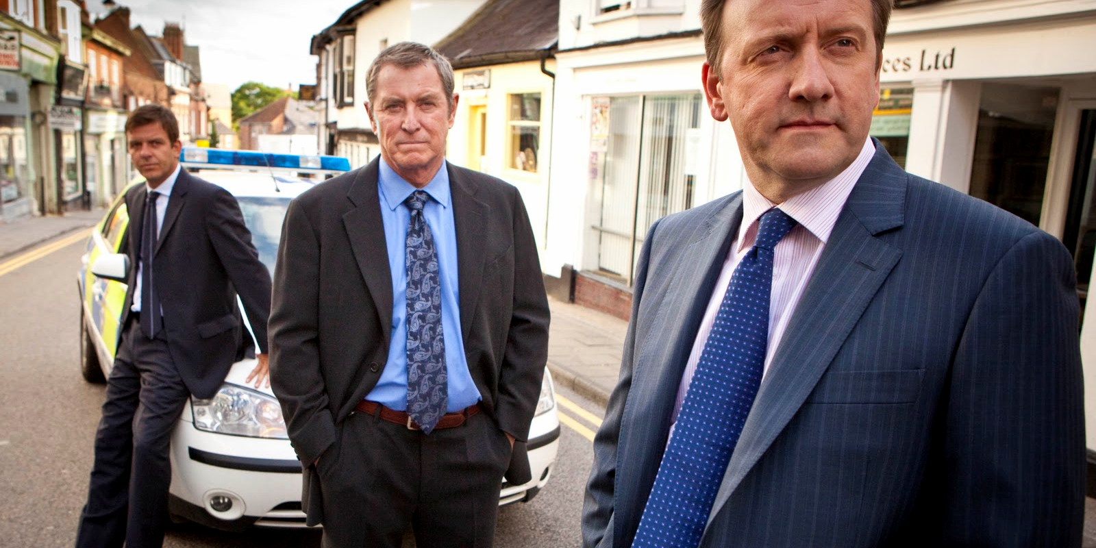 Tom and John Barnaby in front of a squad car in Midsomer Murders