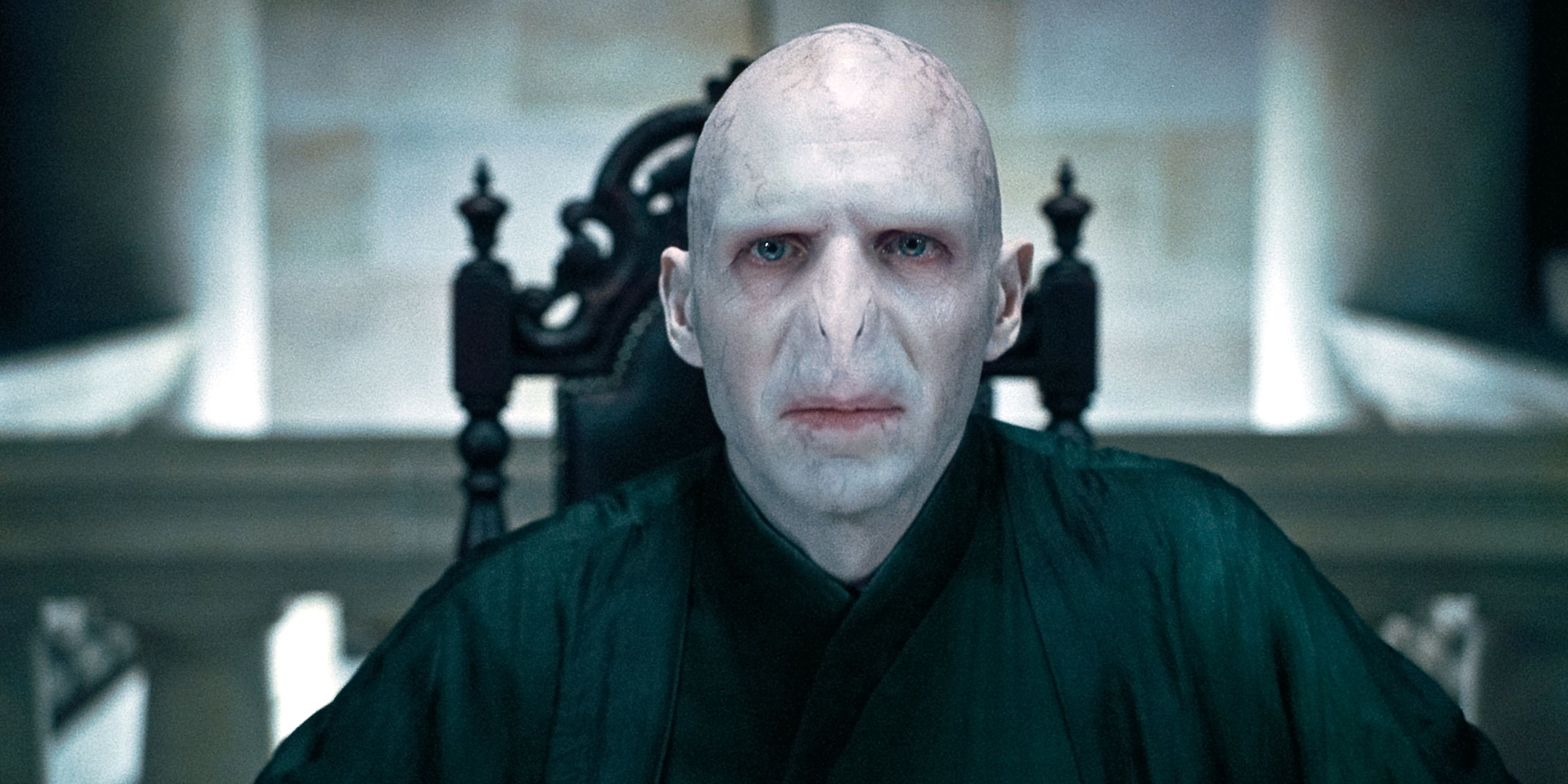 Voldemort sitting at the head of a table in Deathly Hallows Part 1