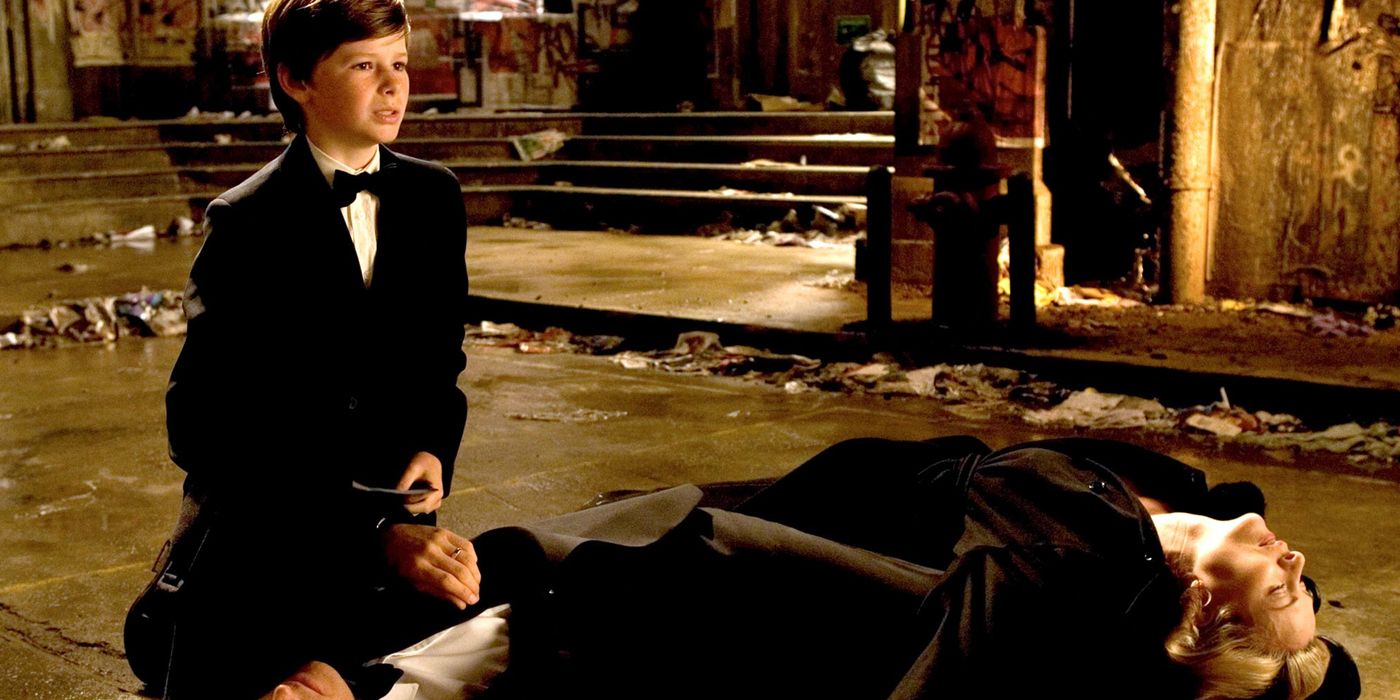 A young Bruce Wayne Cries Over his dead parent's corpses in Batman Begins