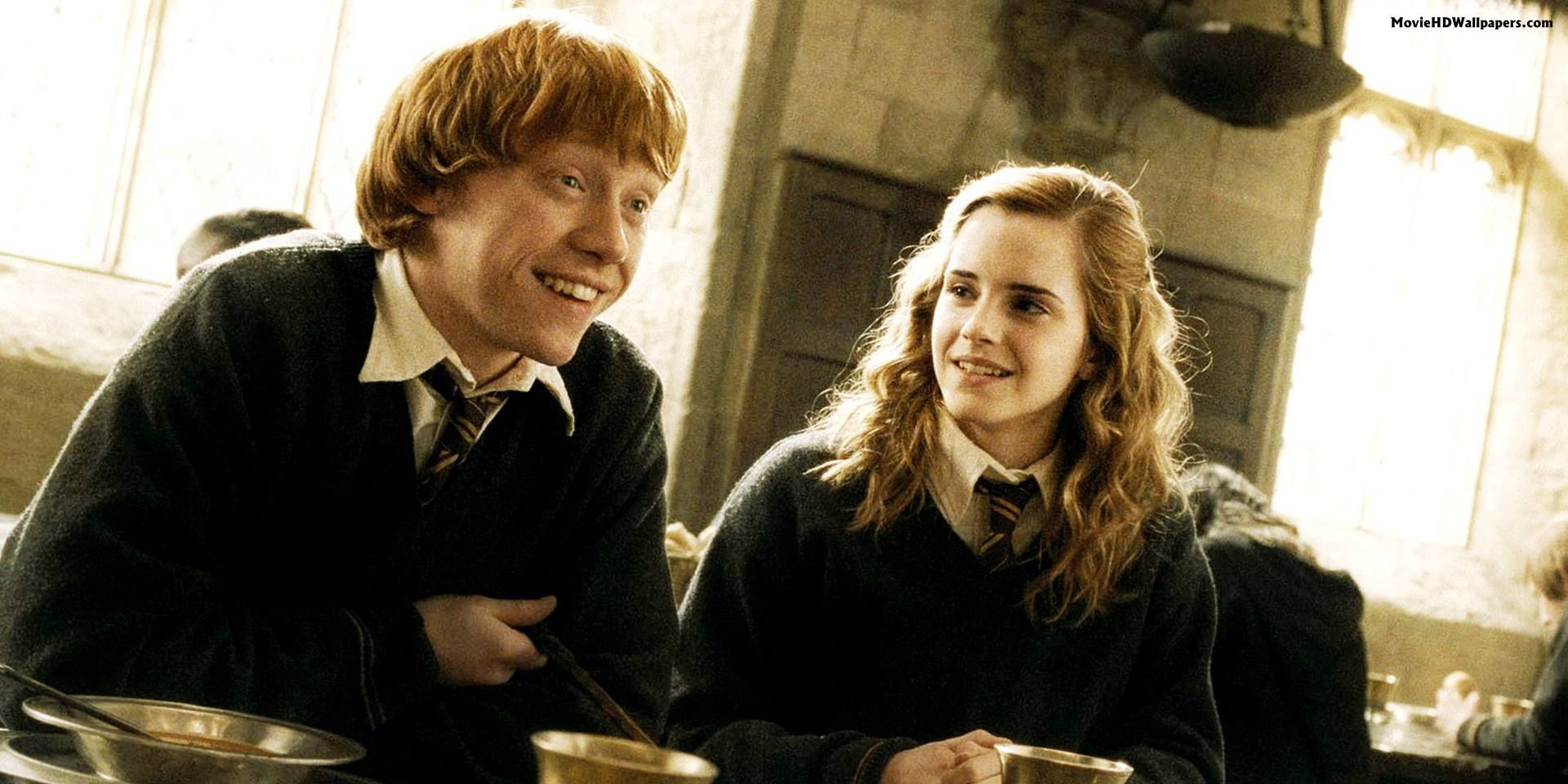 Ron and Hermione laugh in the Great Hall in Harry Potter.